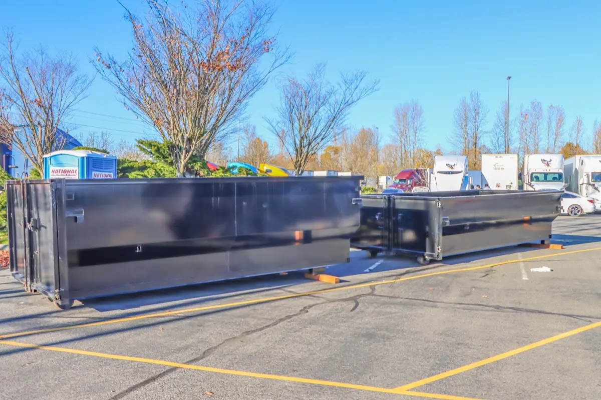 Professional dumpster rental service with roll-off container on residential driveway in Kendallville